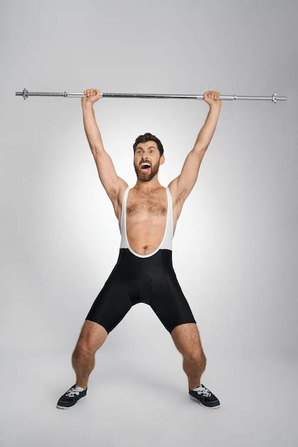 Free Photo | Happy male powerlifter screaming while lifting unweighted ...