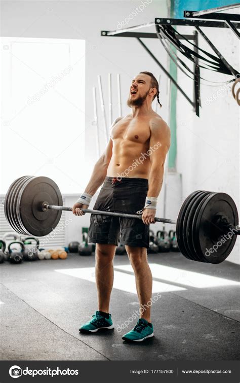 man lifting weights. muscular man workout in gym doing exercises with barbell — Stock Photo ...