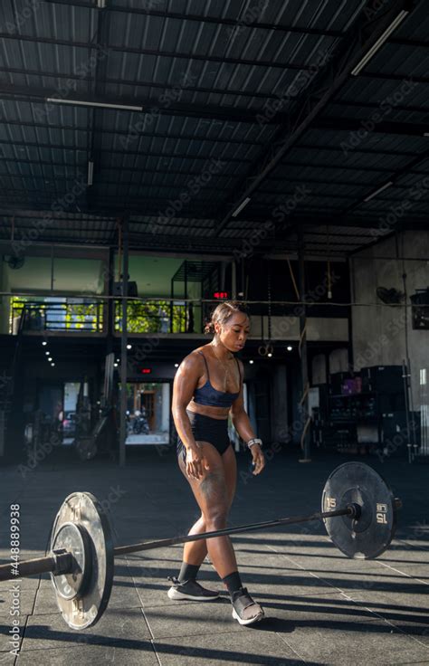 Muscular female athlete lifting heavy weights at gym Stock Photo ...