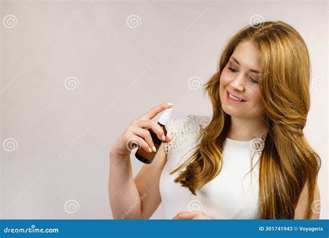 Woman Applying Hair Cosmetic Stock Image - Image of brown, woman: 301741943