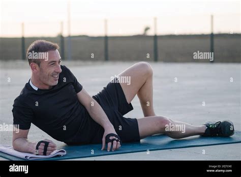 Concept: sport. Man lying on the mat. relaxed resting between sets of ...