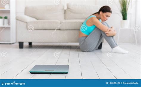 Frustrated Woman Sitting Near Weight Scales at Home, Panorama Stock Photo - Image of body ...