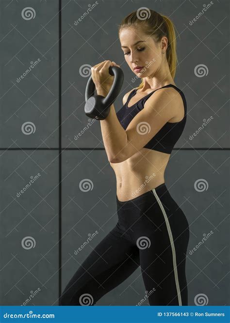 Young Woman Doing Bicep Curls with Kettlebell Stock Image - Image of ...