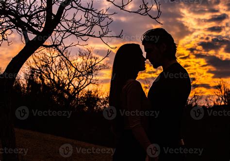 Silhouette of romantic couple in love, man and women in sunset sky. Romantic of relationships ...
