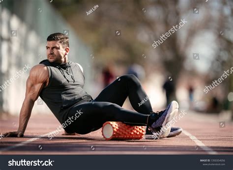 Man Foam Rolling Athlete Stretches Using Stock Photo 1350354056 ...