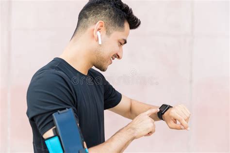 Athlete Checking Results on Smart Watches, Sitting on the Street after ...