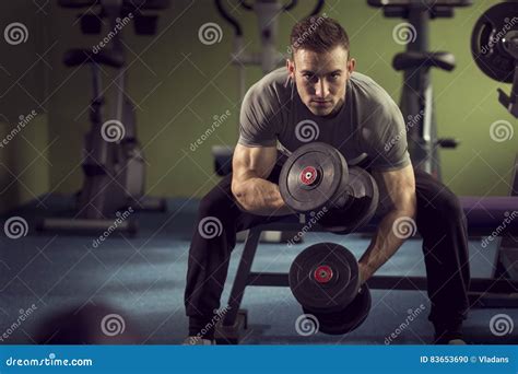 Man lifting weights stock photo. Image of concentration - 83653690