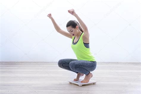 Woman Celebrating Weightloss Goal Achievement Scale Home Stock Photo by ©belchonock 119684440