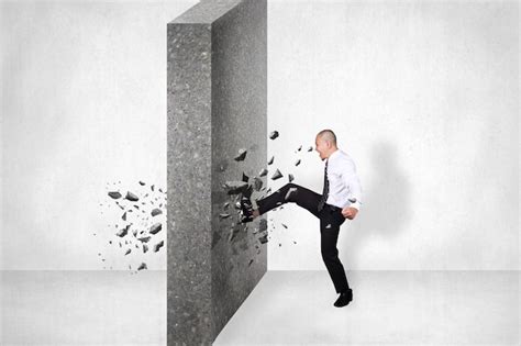 Premium Photo | Businessman breaking wall of obstacle by kick Business ...