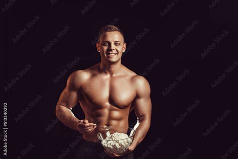 Strong, healthy man posing on a black background. Bodybuilder, athlete ...