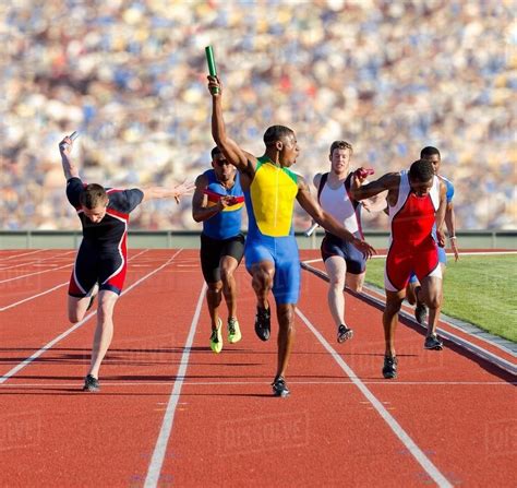 Six athletes running relay race - Stock Photo - Dissolve