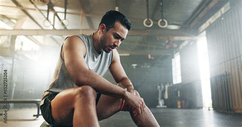 Fitness, breathing and sweating with a tired man in the gym, resting ...