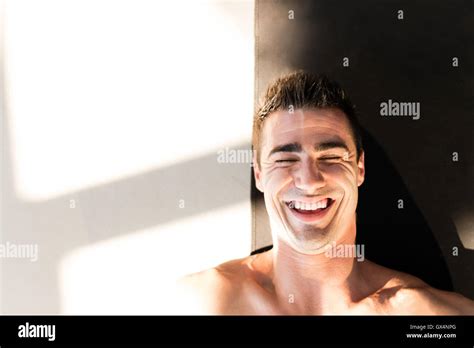 Young muscular man resting after gym workout Stock Photo - Alamy