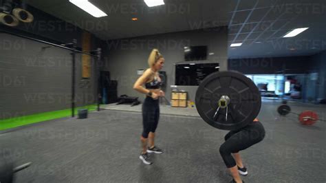 Athletes lifting weights in exercise gym stock photo