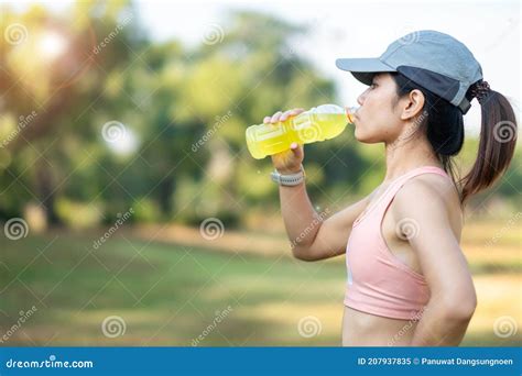 Young Fitness Woman Drinking Energy Water during Stretching Muscle in the Park Outdoor, Asian ...