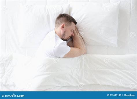 Young Man is Sleeping Peacefully on Large White Bed Stock Image - Image ...