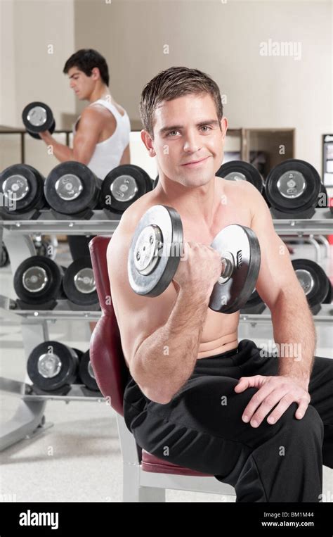 Men lifting weight at gym Stock Photo - Alamy