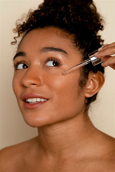 Woman applying serum to face | Premium Photo - rawpixel