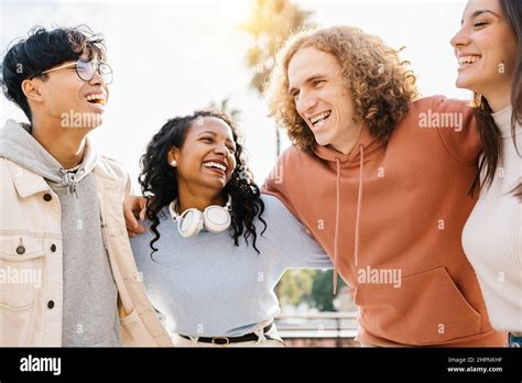 Group of happy young diverse teenage friends laughing together outdoors Stock Photo - Alamy