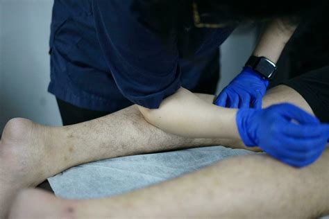 Muscle massage after a hard workout. Physical therapist treats injury ...