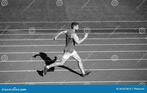 Energetic Athletic Muscular Man Runner Running on Racetrack at Outdoor ...
