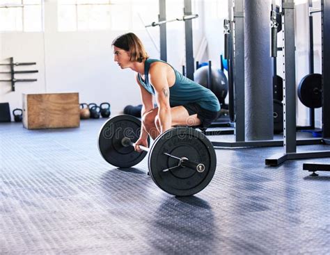 One Fit Young Caucasian Man Doing Deadlifts with a Barbell while ...