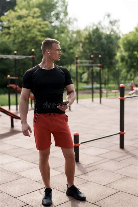 Athletic Man Listening To Music on Sports Ground Stock Photo - Image of ...