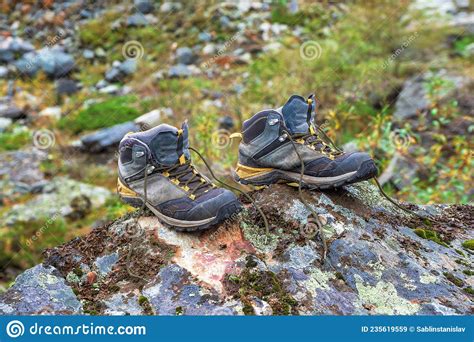 Hiking Boots on Drying. Wet Hiking Boots Dry on a Stone Against the Background of Snow-covered ...