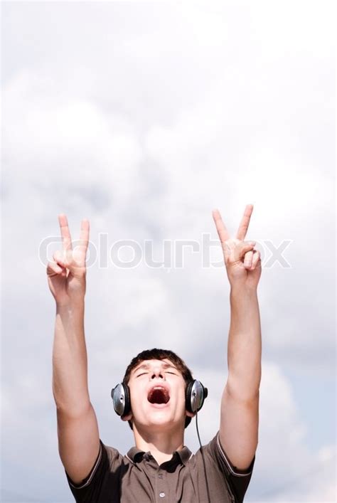Young adult with headphones (focus ... | Stock image | Colourbox