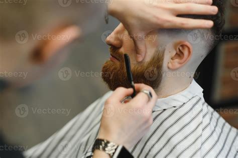 Close up image of barber shaving a man with a sharp steel razor 45667695 Stock Photo at Vecteezy