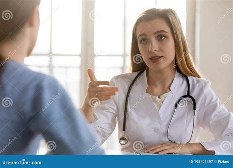 Serious Female Doctor Consulting Patient at Medical Appointment in ...