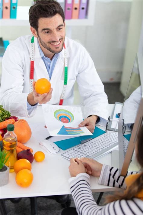 Nutritionist Male Doctor Advising Patient Regarding Healthy Foods Stock ...