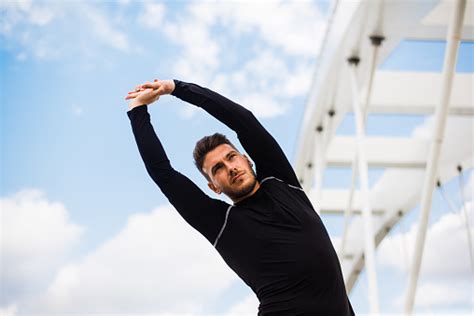 Photo Of An Athletic Man Stretching After Exercise Stock Photo ...