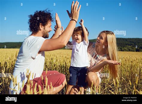 A happy family is enjoying fun with a child outdoors Stock Photo - Alamy