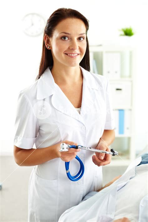 Portrait of confident female doctor with stethoscope looking at camera ...