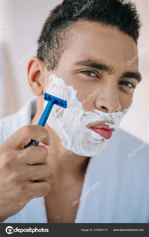 Portrait Shot Handsome Man Shaving Face Razor Looking Camera — Stock Photo © IgorVetushko #279434110