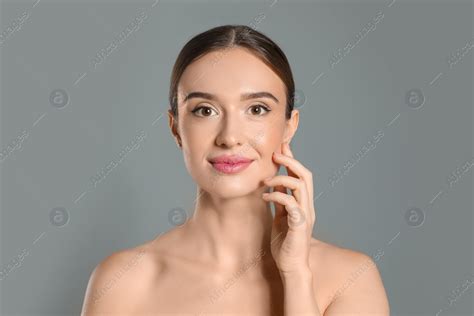 Beautiful woman with perfect smooth skin on grey background: Stock ...