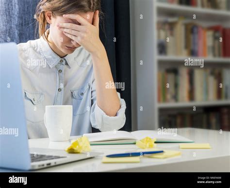 Tired or exhausted person sitting at desk Stock Photo - Alamy