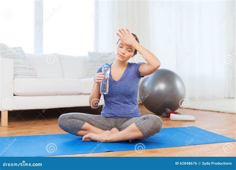 Tired Woman Drinking Water after Workout at Home Stock Photo - Image of ...