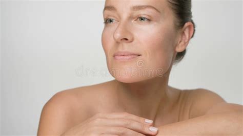Close-up Beauty Portrait of Young Woman with Smooth Healthy Skin, she Gently Touches Her Face ...