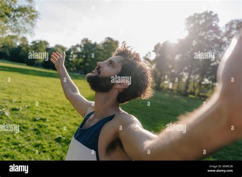 Man enjoying the sunset in a park Stock Photo - Alamy