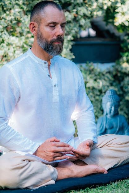 Premium Photo | Peaceful man meditating sitting in lotus position