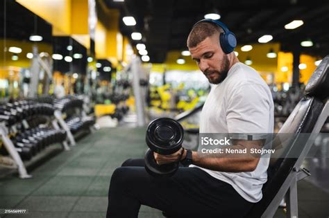 Young Man Lifting Heavy Weights At The Gym Stock Photo - Download Image ...
