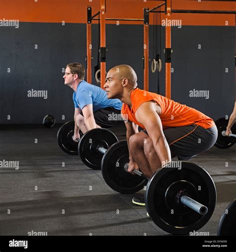 Men lifting weights in gym Stock Photo - Alamy
