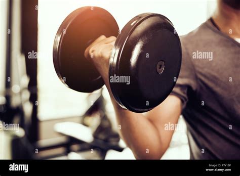 Closeup of dumbbell. young man lifting heavy weights. Sport equipment ...