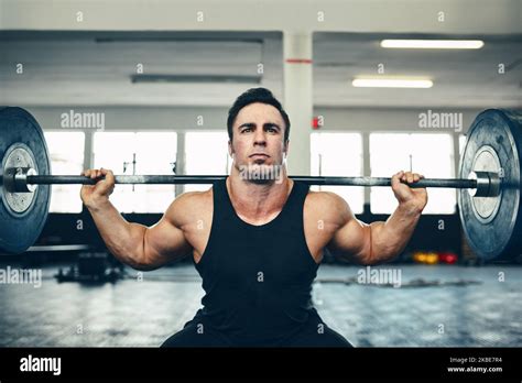 Get fit and do the lift. a man lifting weights at the gym Stock Photo ...