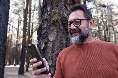One Man Using Phone Cellular Connection in a Forest Wood Enjoying ...