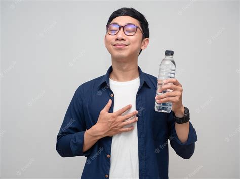 Premium Photo | Positive man feels fresh after drinking water isolated