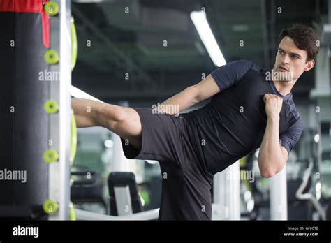 Young man exercising at gym Stock Photo - Alamy
