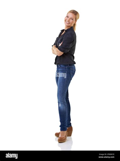 Confident pose. Full length studio shot of a young woman with her arms ...